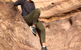 Duke undergraduate Claudia LaRose smiling while sitting on rocks in Petra