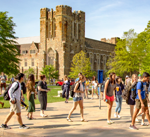 students walking across campus on a sunny day