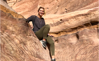 Duke undergraduate Claudia LaRose smiling while sitting on rocks in Petra