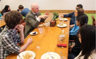 students and faculty eating lunch together around a table