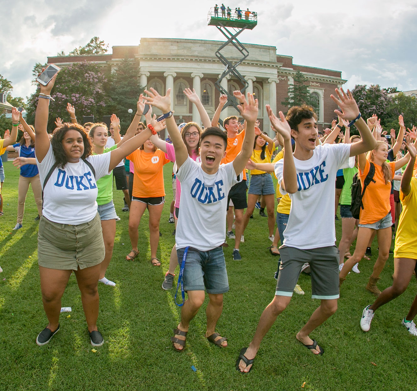 First year students waving their arms in the air with peer advisors
