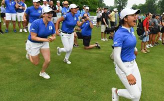 students on the women's golf team cheering on the course